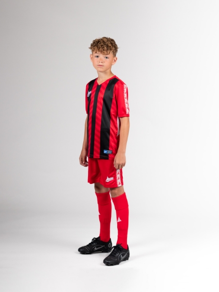 The child is wearing a football kit that has red and black stripes