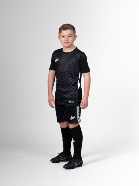 This childrens footballer is wearing a full black football kit.