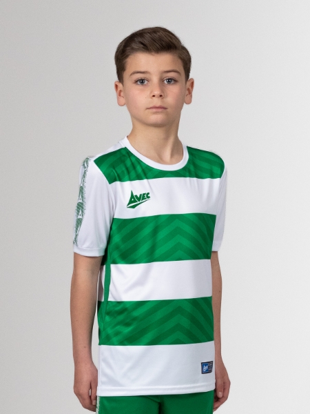 A young boy proudly wears a green and white football shirt