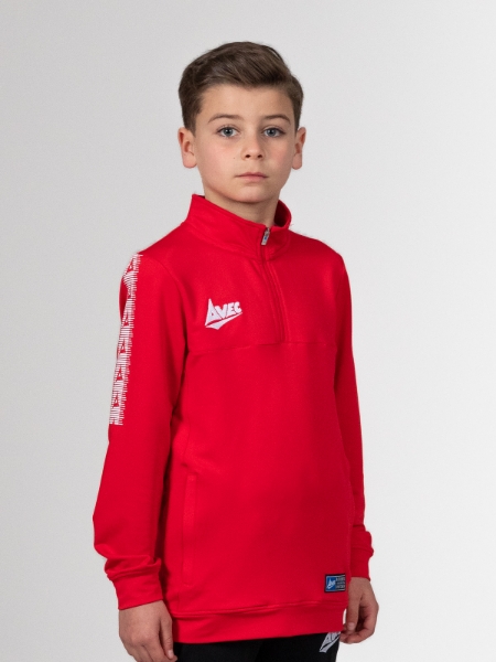 A young boy is wearing a red jumper to keep warm.