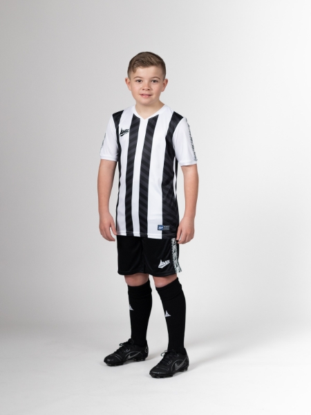 This child is wearing a black and white football shirt, which is made famous by teams such as Newcastle United, Juventus and Notts County