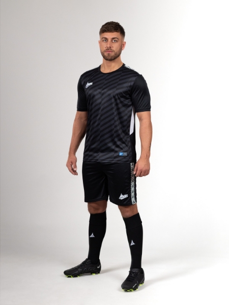A stylish black football kit is a class above the rest. This man is wearing a black shirt, black shirts and black socks for for striking design.