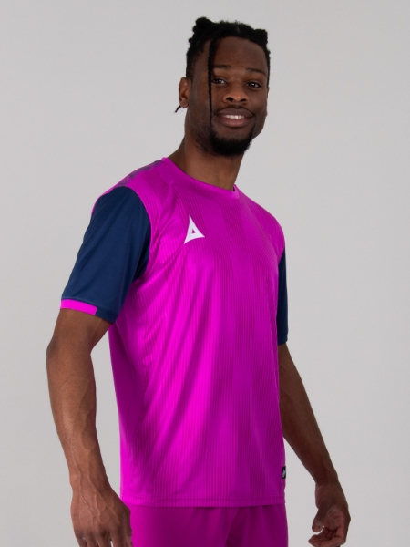 A bright purple football shirt, with navy sleeves is worn by a man.
