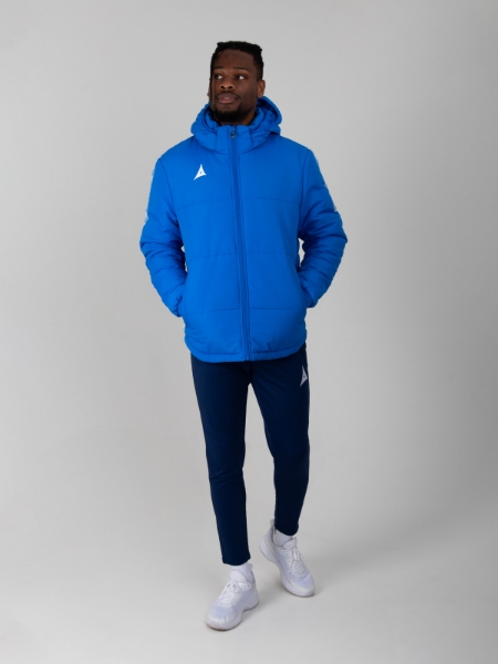 This man is wearing a royal blue winter coat to keep him warm against the cold.