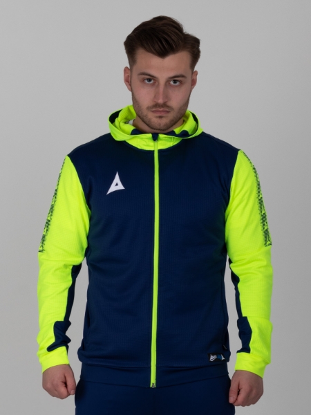 A man wearing a a navy hoody with neon yellow sleeves and hood. 