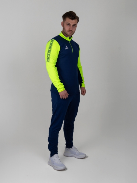 A man is wearing a navy sweat top with florescent yellow sleeves