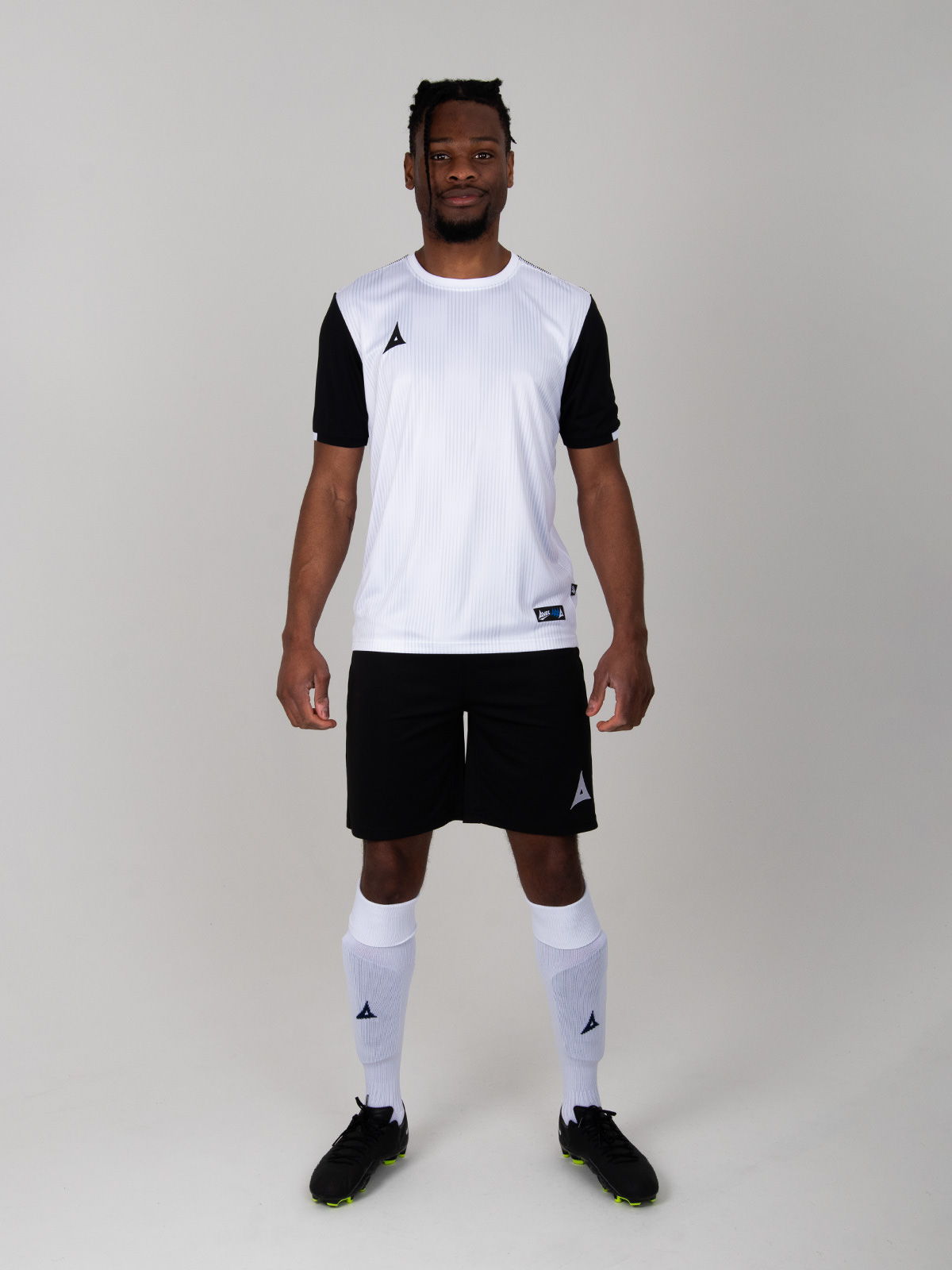 this person is wearing black shorts with a white kit
