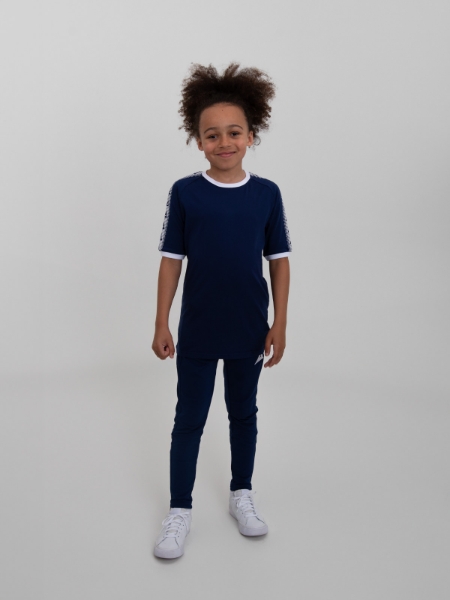 A navy ringer t-shirt with white trim is won by a junior