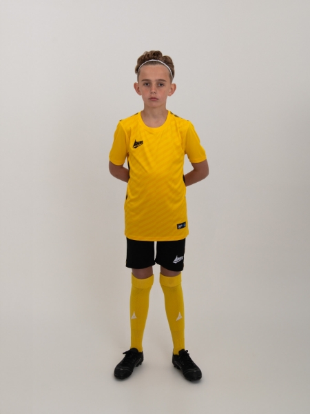 A junior football kit consisting of yellow and black is worn by a child.