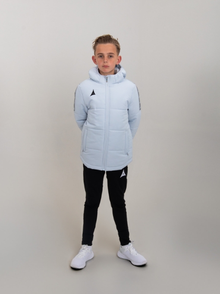 A kids padded jacket in light grey is bring worn by a young child