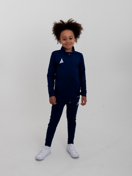 This boy is wearing a plain navy tracksuit top with matching tracksuit bottoms