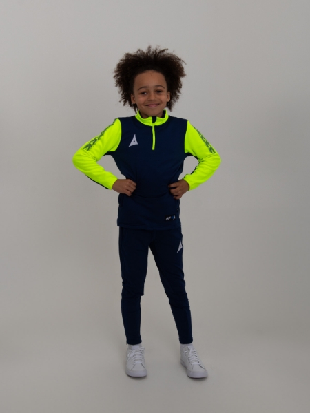 A kid with is hands on his hips wearing a navy blue sweat top with neon yellow sleeves.