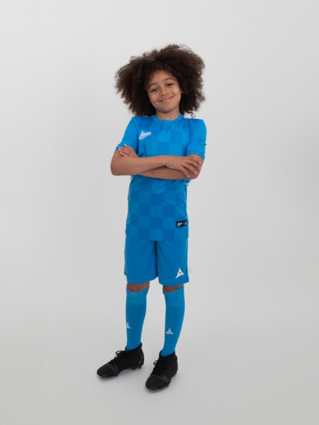 A young boy is wearing childrens sky blue shorts