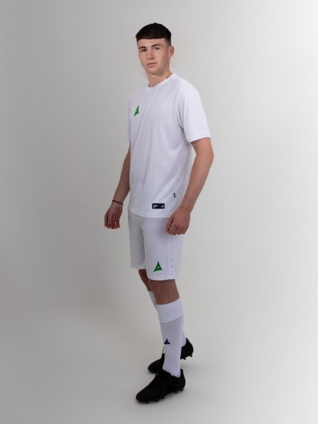 The man in the image is wearing white shorts with a green logo