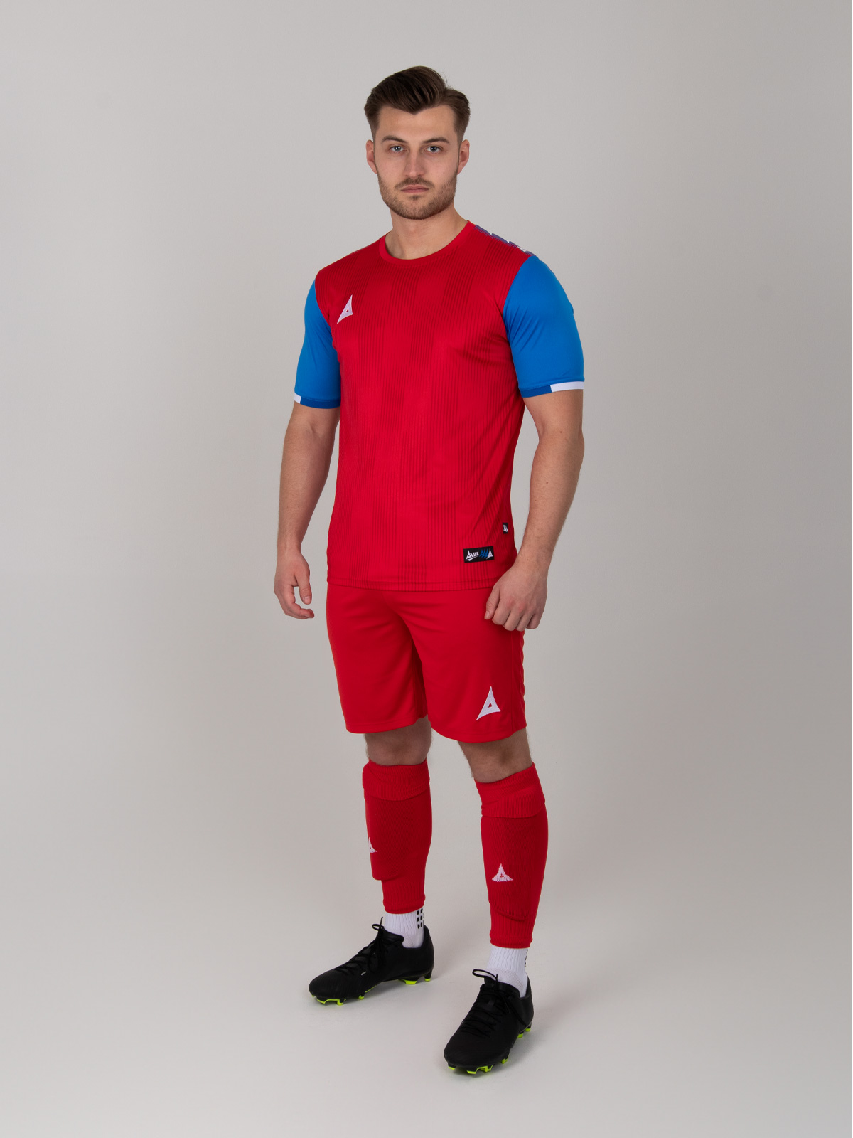 to illustrate our red football shirts a man is wearing a full red football kit