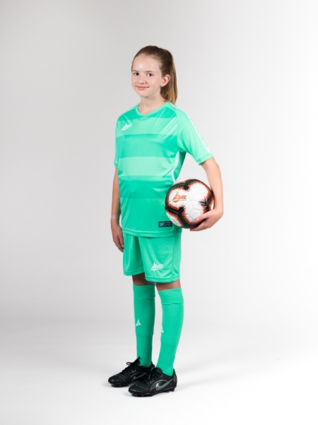 This child is wearing turquoise football shorts