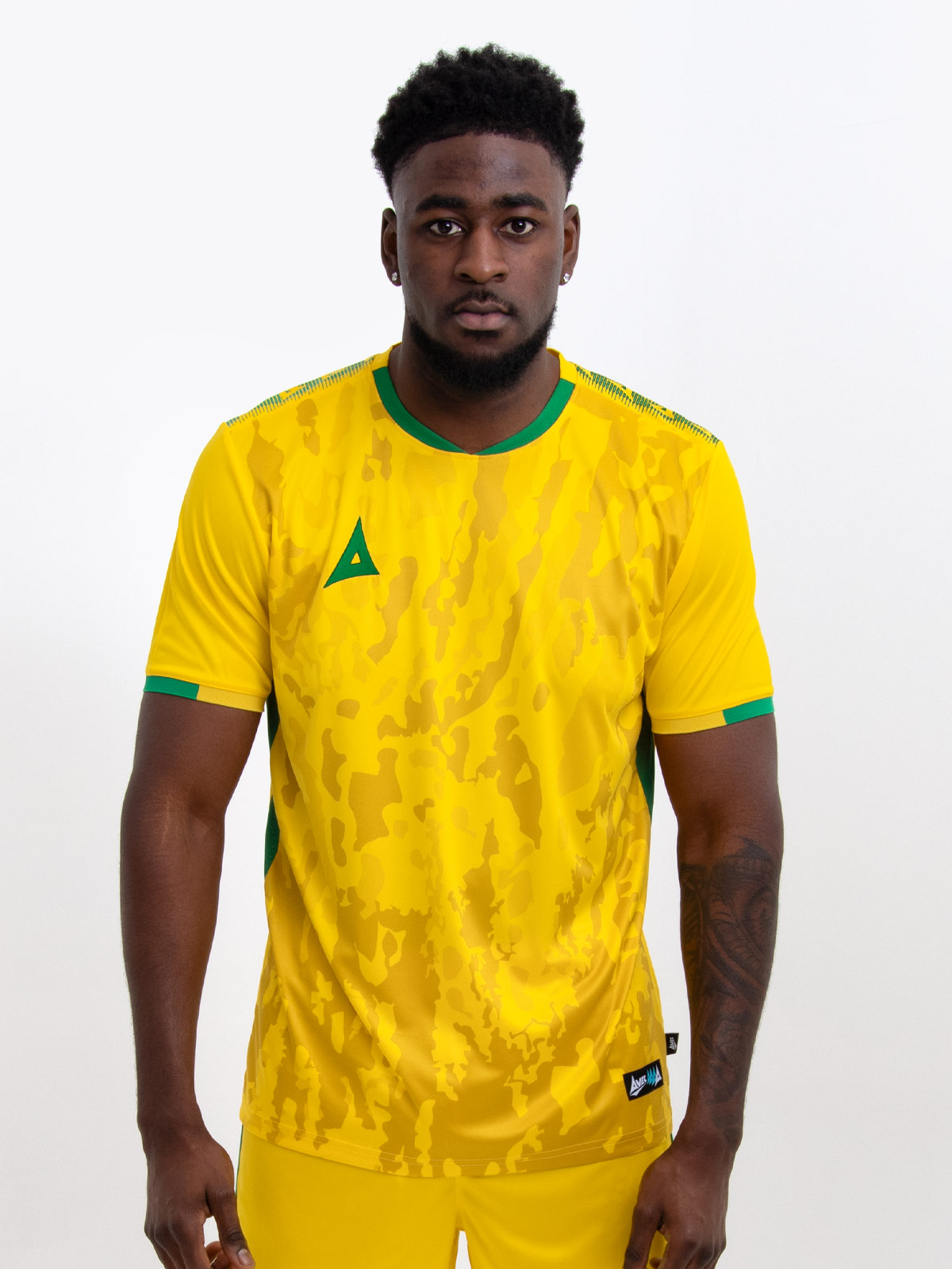 model wearing a yellow sports football training t-shirt with green accents