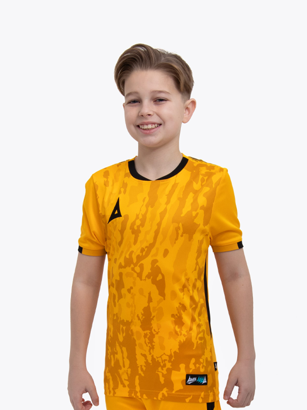 a young child is wearing an amber and black football shirt. the football shirt has a camo pattern