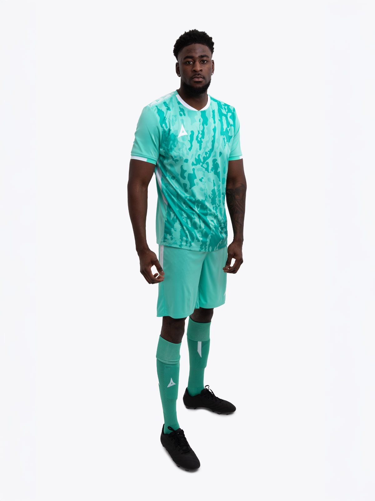 a model standing up wearing a mint green / hyper green football training shirt, mint green / hyper green shorts and mint green / hyper green football socks.