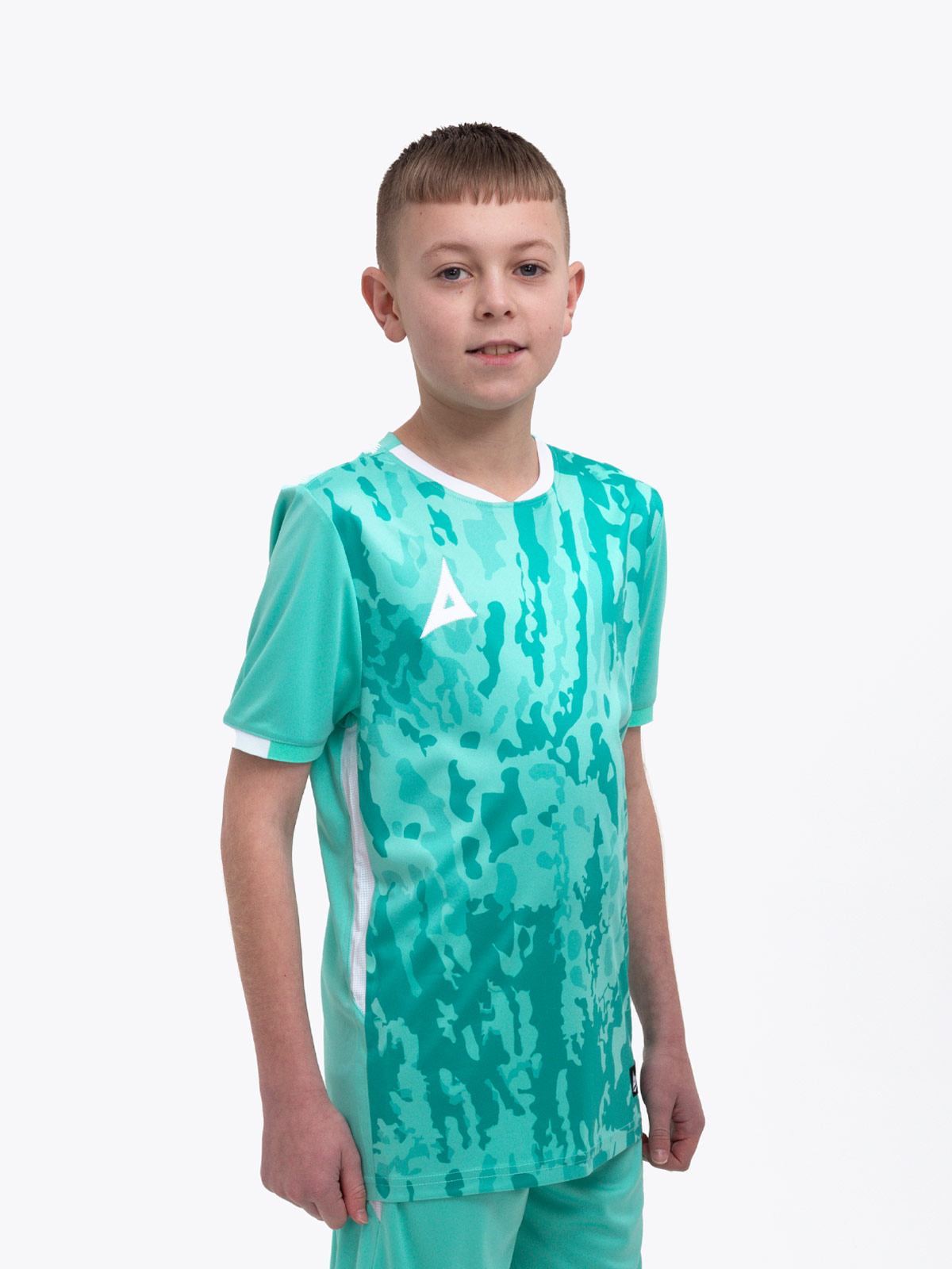 a young child is wearing a mint green / hyper green football shirt . the football shirt has a camo graphic