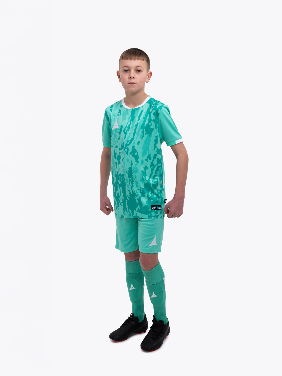 a kids football kit in mint green / hyper green
