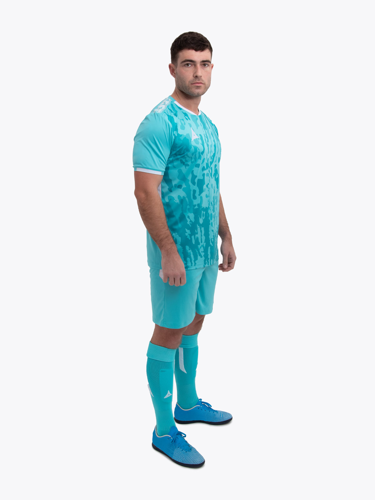 a model standing up wearing a hyper blue football shirt, hyper blue shorts and hyper blue football socks.