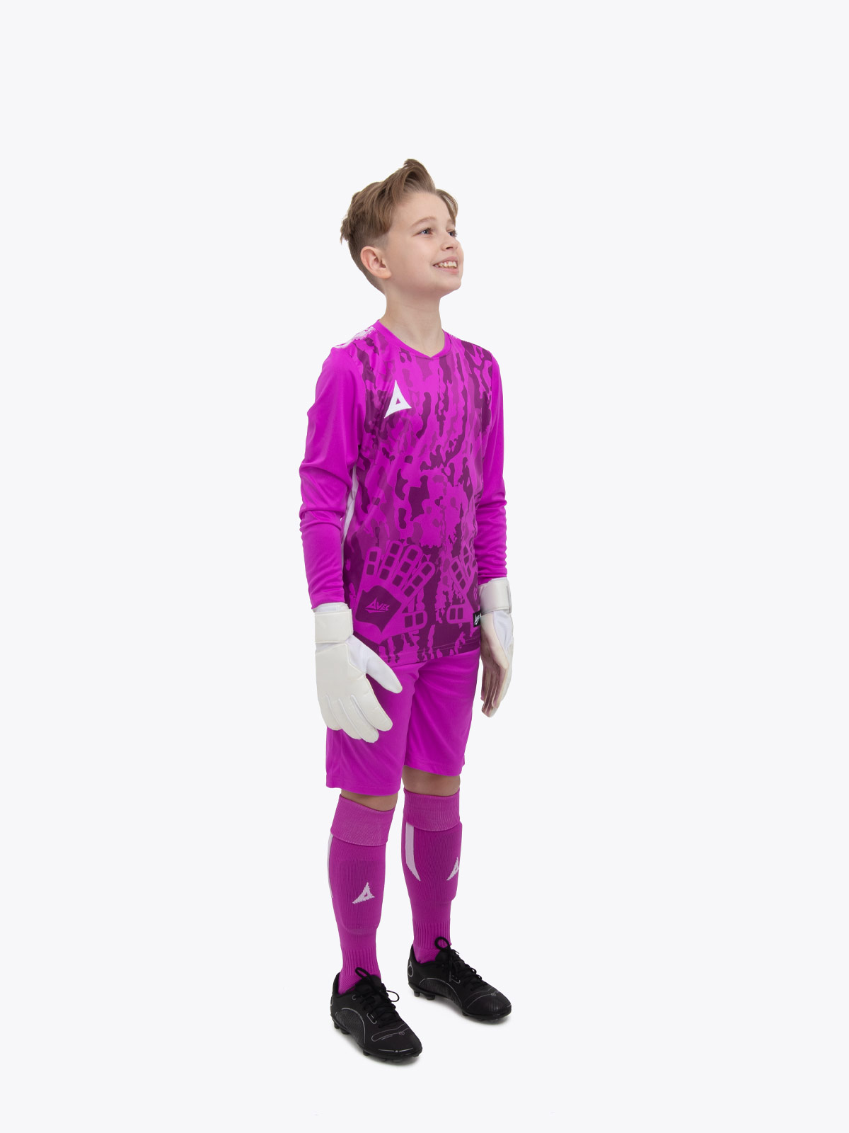 a young child is wearing a full magenta goalkeeper football kit