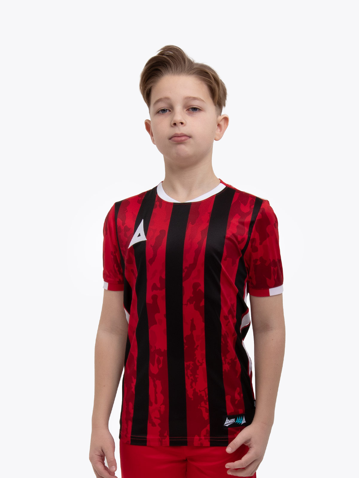 a young child is wearing a red and black striped football shirt. the football shirt has a camo pattern