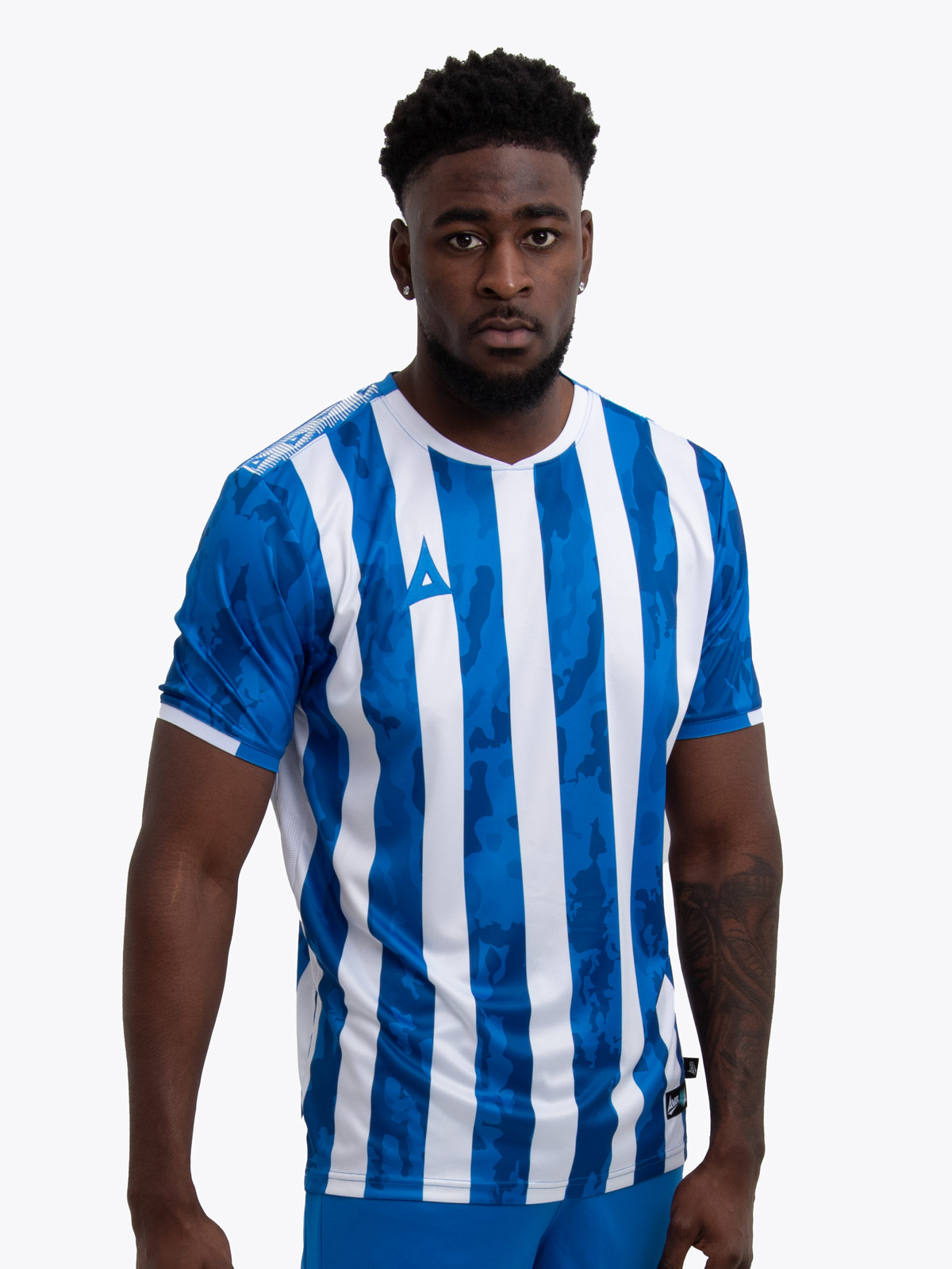 a man is wearing a royal blue and white stripe football shirt, which can be customised with a badge and sponsor for a grassroots team