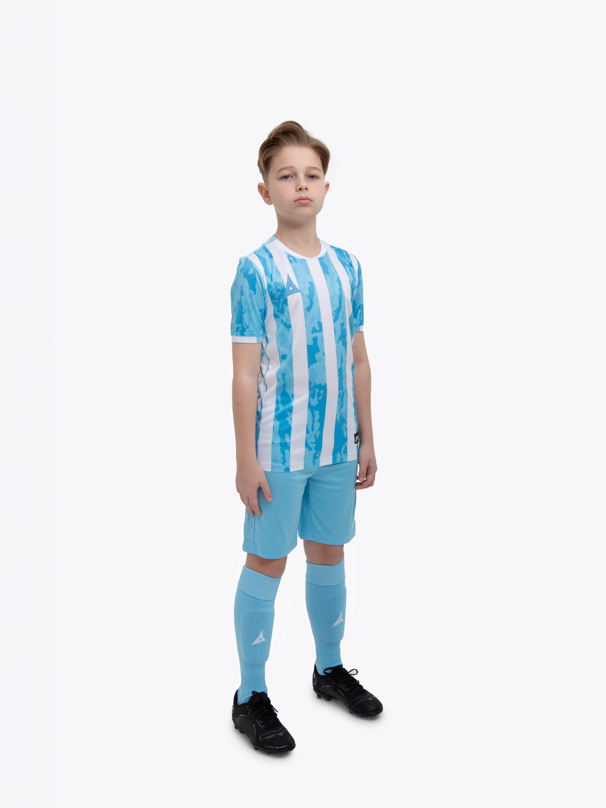a kid is wearing a sky blue and white shirt, alongside sky blue shorts and sky blue socks