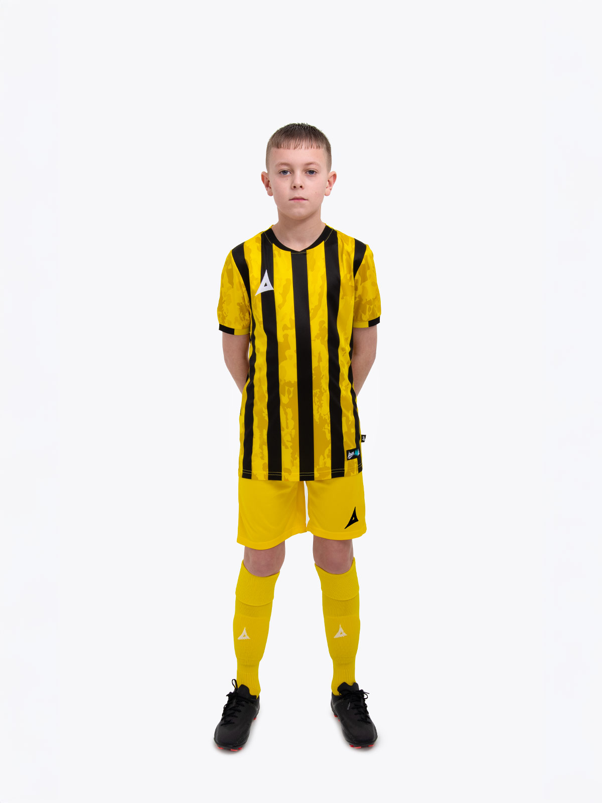 a kids football kit in yellow and black with stripes and matching yellow shorts and socks