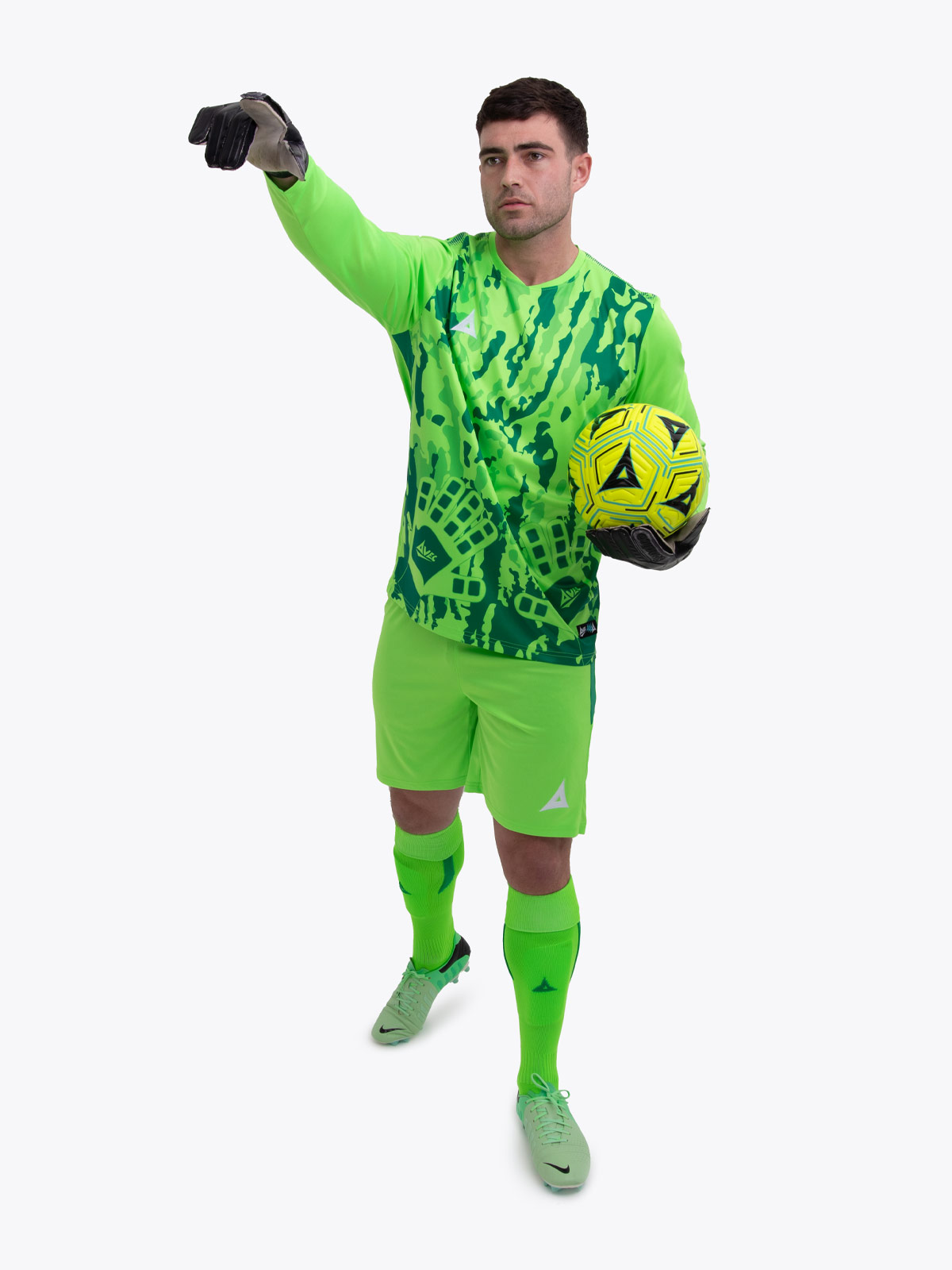 a model standing up wearing a neon green goalkeeper football shirt, neon green shorts and neon green football socks.