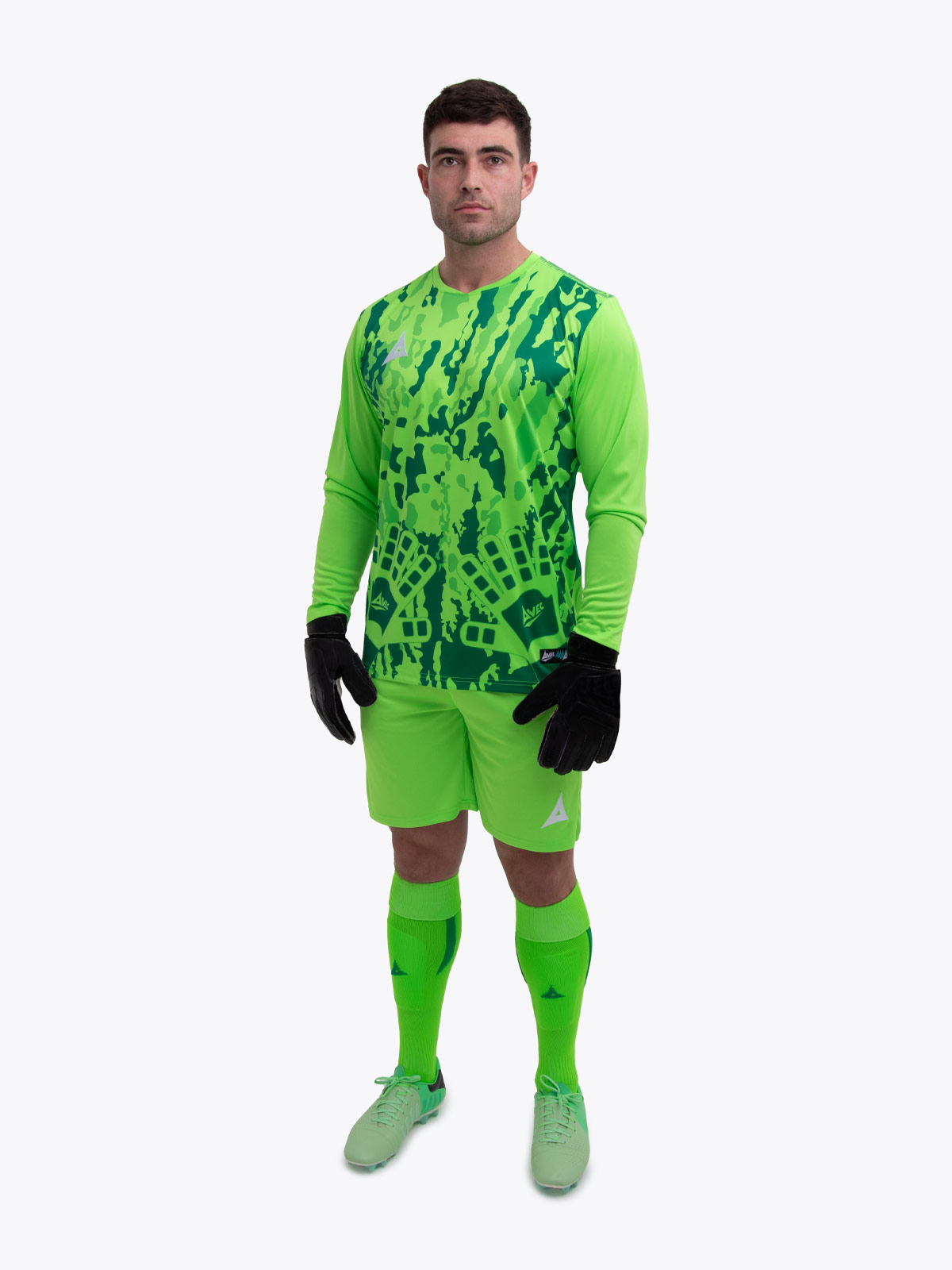 a model is wearing a neon green goalkeeper football shirt. the football shirt has a camo pattern