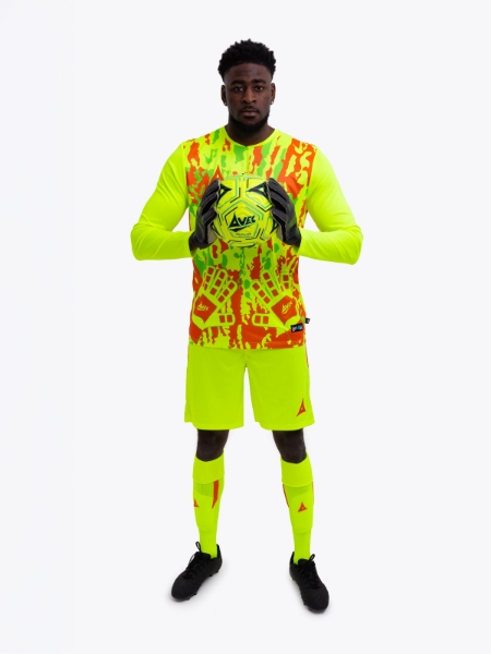 A model is wearing a full neon yellow goalkeeper football kit and holding a neon yellow football matching the kit