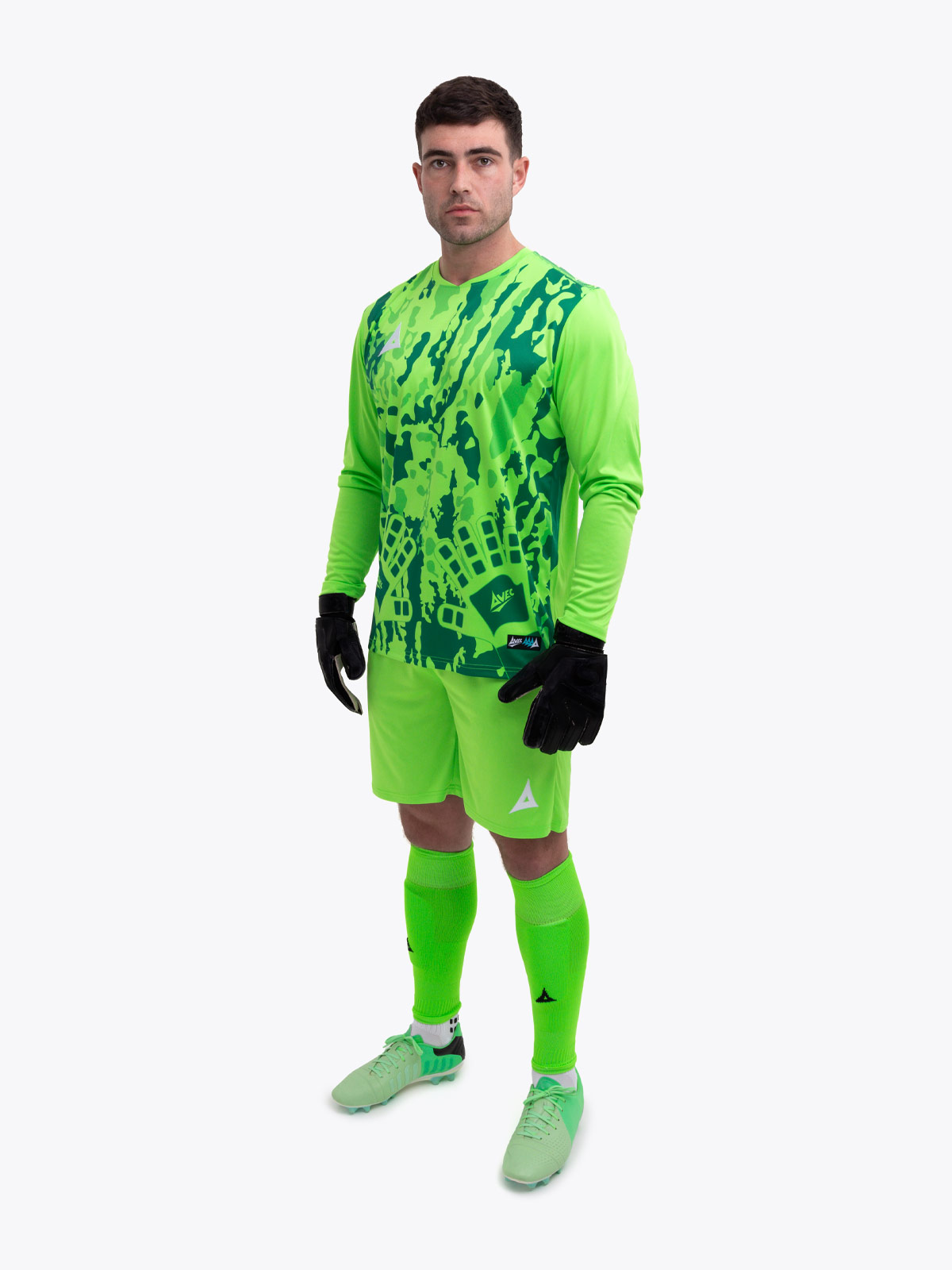 a man is wearing a full neon green goalkeeper football kit