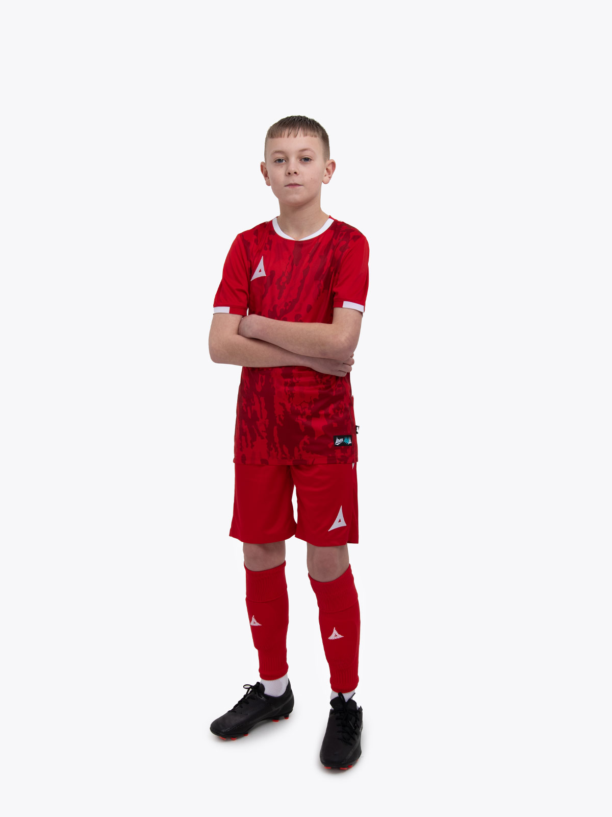 a child is wearing a red and football kit 