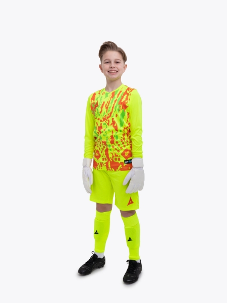 A young boy is wearing a full neon yellow goalkeeper football kit with an orange trim and detailing