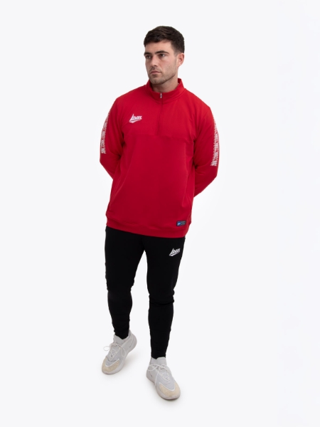 This smart looking sports outfit is being worn by a man. The red jumper features a quarter zip